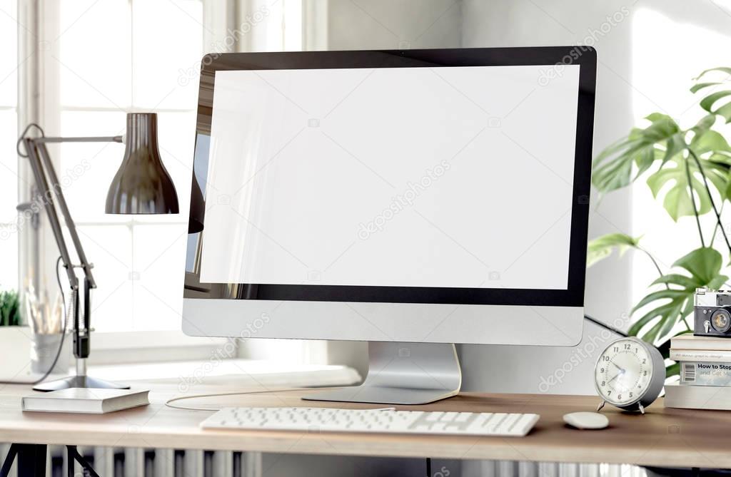 white empty computer screen with table lamp and books on desktop  