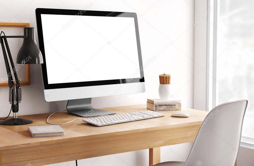 white empty computer screen with table lamp and books on desktop 