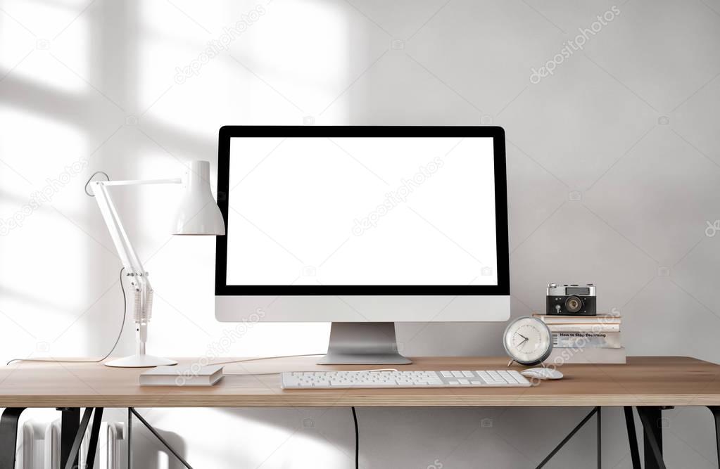 white empty computer screen with table lamp and books on desktop    