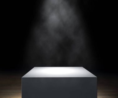 Lighted podium on wooden floor on black background clipart