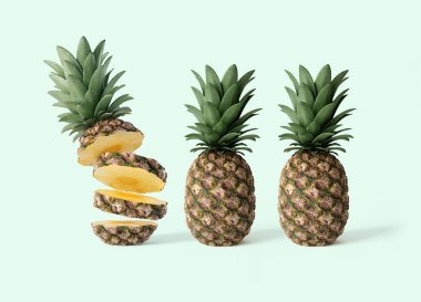 Bir dilimlenmiş ve nane arka plan üzerinde iki bütün ananas