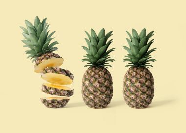 Bir dilimlenmiş ve Sarı zemin üzerine iki bütün ananas