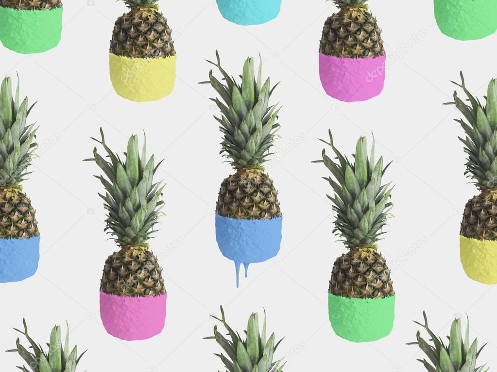 Set of ripe pineapples with colored halves on grey background 