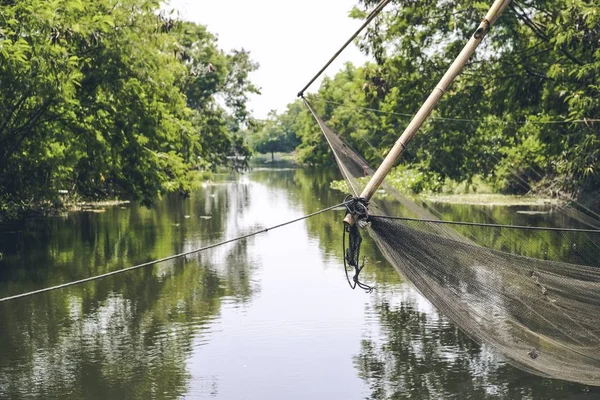 Ancient fishing tools are located along the canal in rural Thailand