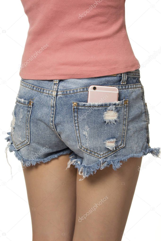 Sexy woman with a cell phone in her back pocket isolated on a white background