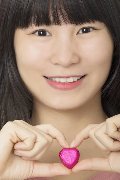 Asiatico donna holding un cioccolato caramella isolato su bianco backgrou — Foto Stock