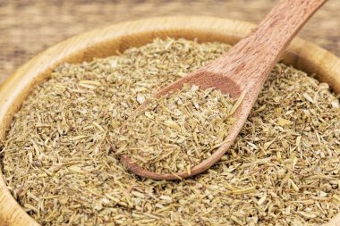 Lezzetli İtalyan baharatlarıyla dolu ahşap bir kase.