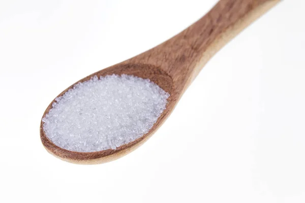 Spoon full of granulated sugar  on a white background — Stockfoto