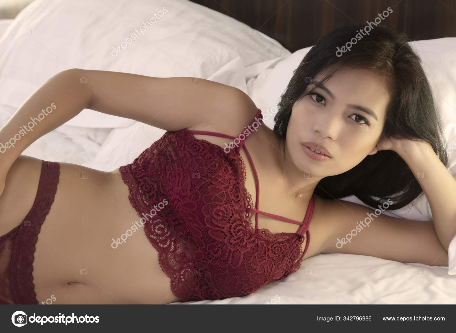 Beautiful Asian woman posing nude on white sheets Stock Photo by ©dndavis 342796986 picture