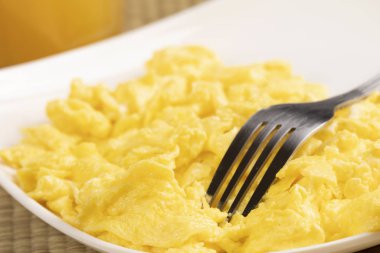 Delicious breakfast of scrambled eggs with copy space