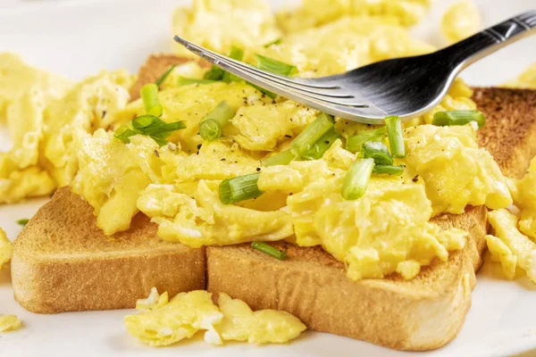 A delicious breakfast of scrambled eggs and toast with copy space