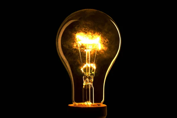 Siyah arka plan üzerine soyut ampul. Karanlıkta ışık lamba. Elektrikli ampul. Karanlıkta parlayan ışık.