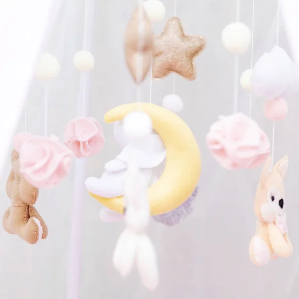 baby toys over the crib lullaby delicate cream color