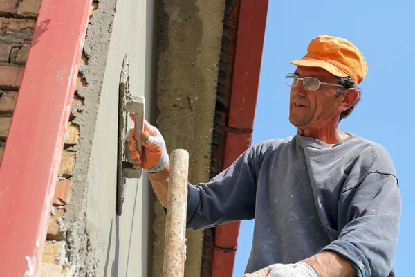 Builder Worker At Plastering Facade Work Stock Photo