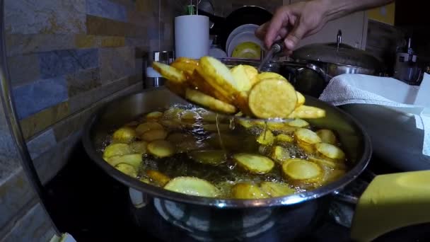 Patatas fritas que se sacan del aceite de cocina caliente — Vídeo de stock