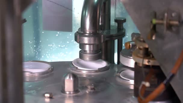 Machine de remplissage et d'étanchéité rotative de tasse de yaourt - mouvement lent. Production et embouteillage de yaourt dans des tasses en plastique. Remplissage et emballage de yaourts dans une usine laitière .