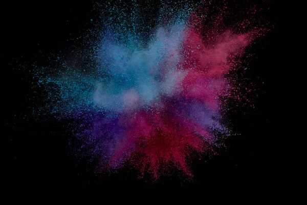 Colored powder explosion. Abstract closeup dust on backdrop. Col