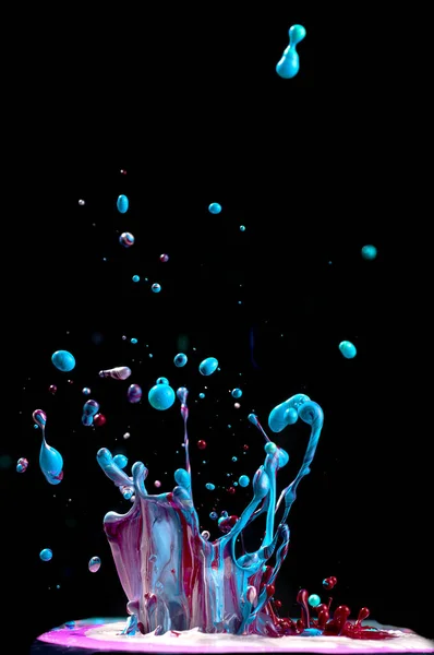 Dancing colored paint. Abstract sculpture dye. Splash of ink on a black background