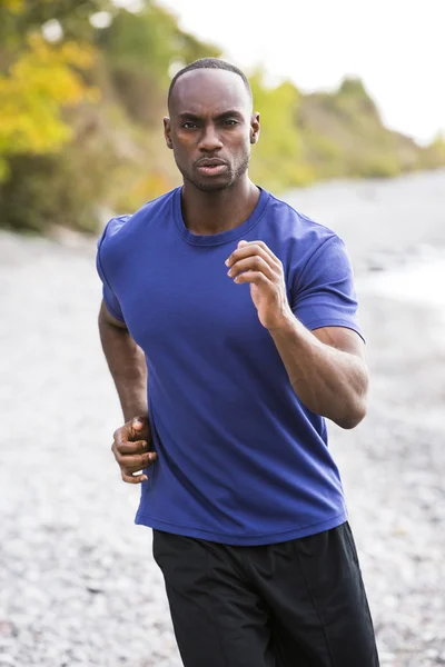 Young man running outdoors Royalty Free Stock Photos