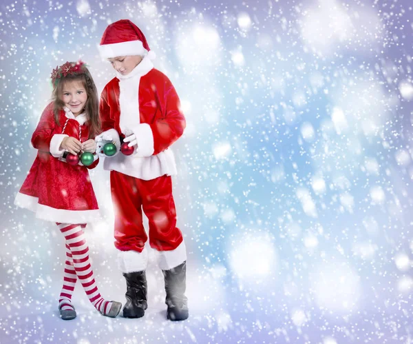 Boy and girl as santa and elf — Stock Photo, Image