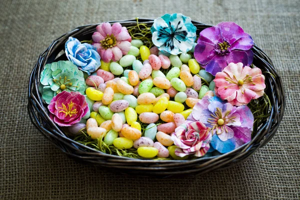 Πασχαλινά αυγά με λουλούδια την άνοιξη στην υφή σάκο — Φωτογραφία Αρχείου