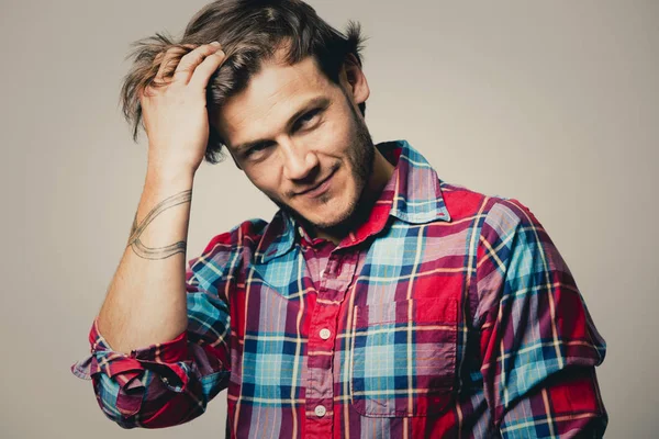 Caucasian man wearing checkered shirt and trendy hairstyle — Stock Photo, Image