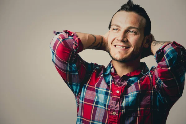 Caucasian man wearing checkered shirt and trendy hairstyle — Stock Photo, Image