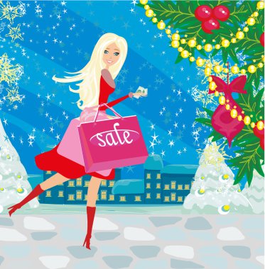 Güzel bir kadın kışın alışverişe çıkıyor. 