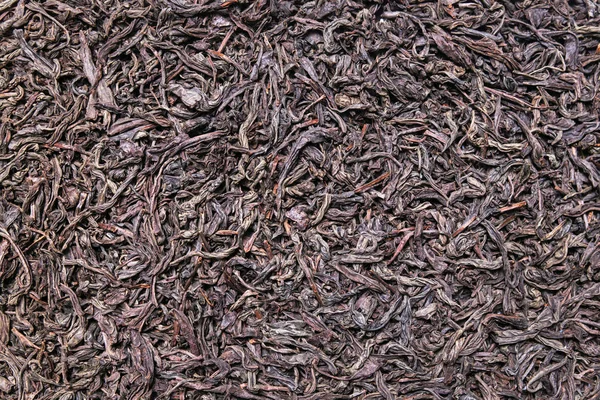 Sušené černý čaj zanechává pozadí, textury — Stock fotografie