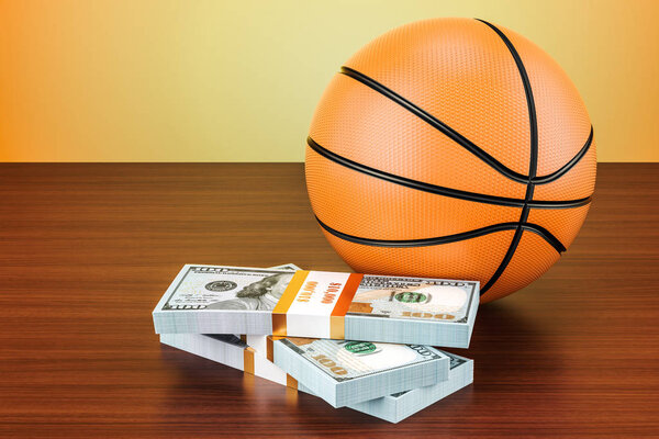 Sport bets. Basketball ball with dollar packs on the wooden tabl