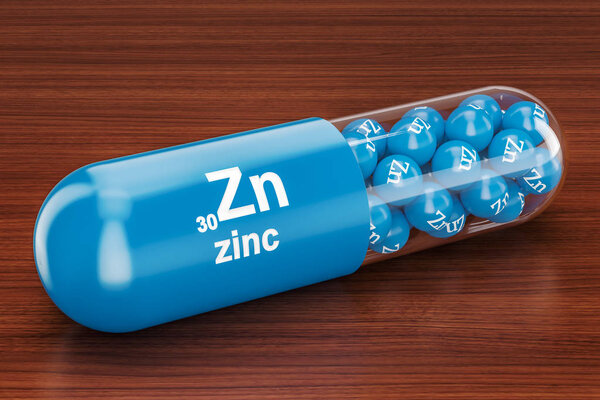 Capsule with zinc Zn element on the wooden table. 3D rendering