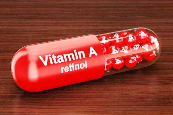 A-vitamin kapszulát a fából készült asztal. 3D-leképezés — Stock Fotó