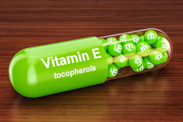 Vitamin E capsule on the wooden table. 3D rendering