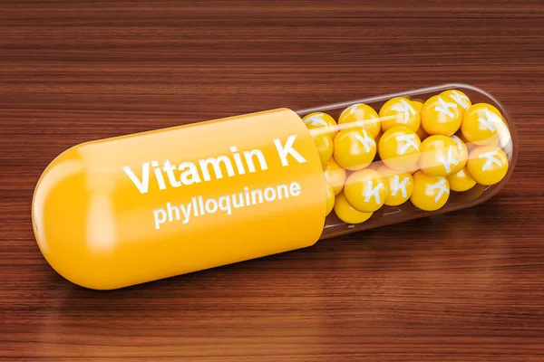 Vitamin K kapszula a fából készült asztal. 3D-leképezés — Stock Fotó