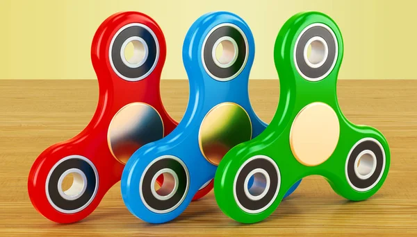 Conjunto de fidget spinners coloridos na mesa de madeira. Renderização 3D — Fotografia de Stock