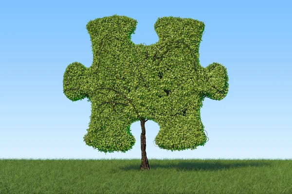 Zielone drzewo w kształcie puzzle na zielonej trawie przed blu — Zdjęcie stockowe