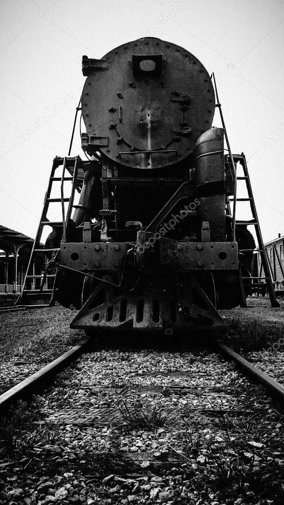 Front view of a retro steam locomotive on a railroad