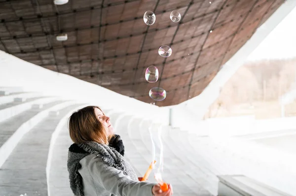 woman blowing soap bubbles