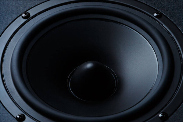Black and white image of a membrane sound speaker isolated on a black background