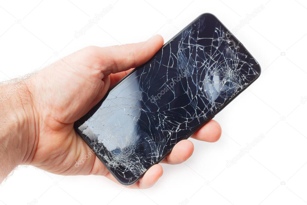 Hand holds a broken smartphone on a white background