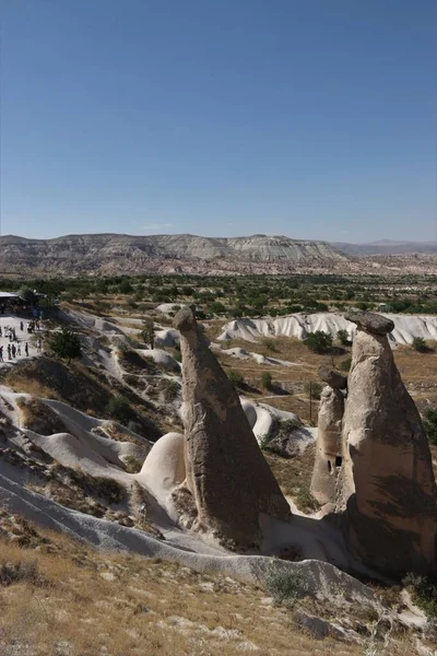 Les touristes visitent quelques-unes des célèbres cheminées de fées en Cappadoce — Photo