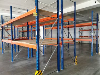 empty heavy duty racks in a company as production is at a standstill clipart