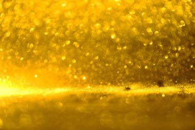 Altın glitter doku doğum günü, yıldönümü, düğün, yeni yıl arifesi ya da Noel için arka plan Derma bulanık.
