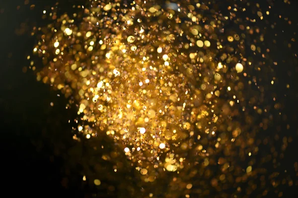 Altın glitter doku doğum günü, yıldönümü, düğün, yeni yıl arifesi ya da Noel için arka plan Derma bulanık.