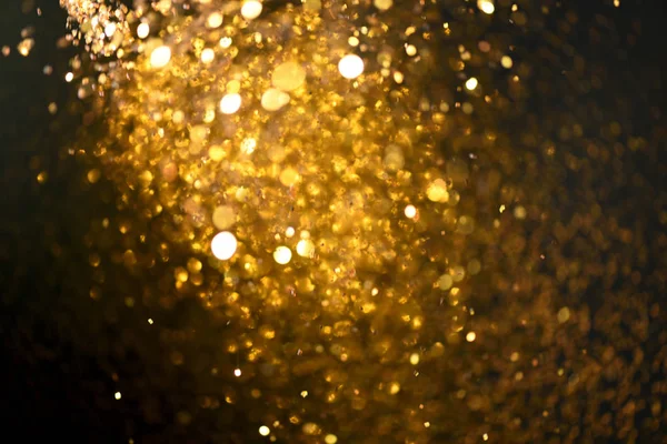 Altın glitter doku doğum günü, yıldönümü, düğün, yeni yıl arifesi ya da Noel için arka plan Derma bulanık.