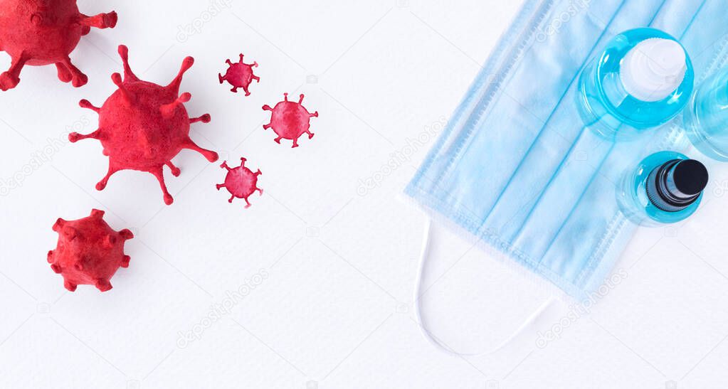 Coronavirus (COVID-19) that Built by molding clay with watercolor painted has surgical masks and hand sanitizer gel for hygiene spread protection on white paper background.