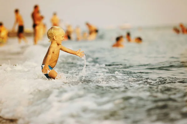 Kid plaing com onda no mar — Fotografia de Stock