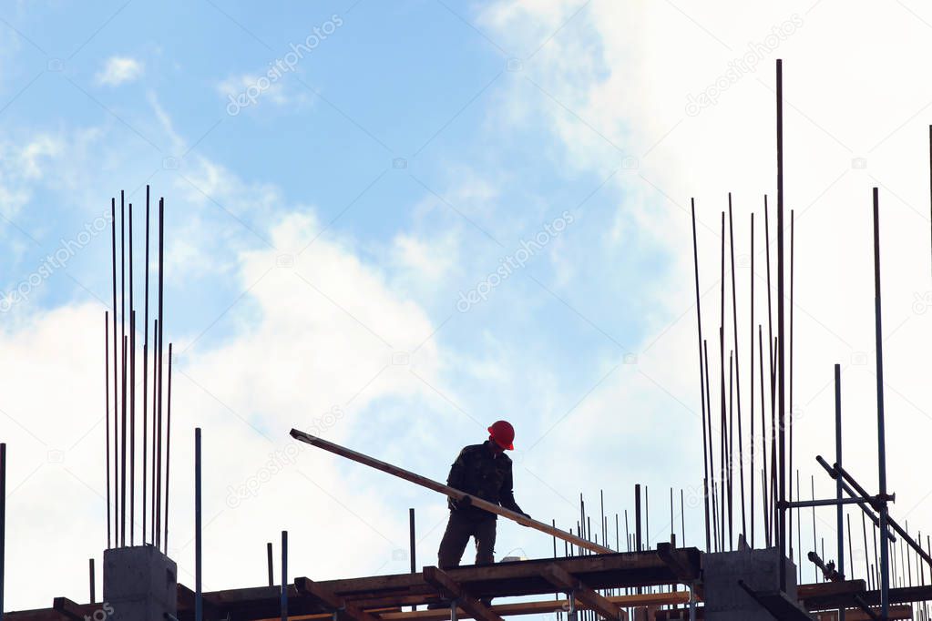 Team of  workers building pile with blue sky on the backgrounds. New skyscraper.