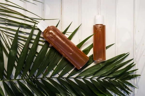 İki jel şişe ve arka plan üzerinde beyaz ahşap masa ve bir pa