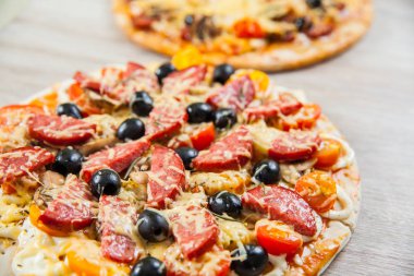 Üst iki Pizza mantar, zeytin ve domates, sosis ile görüntüleyin. Biberiye ve taze sebze. Taze ev yapımı